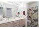 Bright bathroom with a double sink vanity and a shower with a curtain at 345 S Buena Vista Ave, Gilbert, AZ 85296