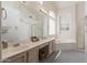 Bathroom featuring double sinks, a large mirror and a soaking tub at 345 S Buena Vista Ave, Gilbert, AZ 85296