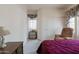 Bedroom featuring soft carpet, a large closet and warm natural light at 345 S Buena Vista Ave, Gilbert, AZ 85296