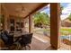 Inviting covered patio featuring ceiling fans, and views of a custom pool and outdoor kitchen area at 345 S Buena Vista Ave, Gilbert, AZ 85296