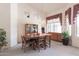 Comfortable dining area featuring a wooden table, padded chairs, soft lighting and decor at 345 S Buena Vista Ave, Gilbert, AZ 85296