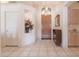 Bright entry foyer with tiled flooring, a wooden door, and decorative niche for flowers, offering a warm welcome at 345 S Buena Vista Ave, Gilbert, AZ 85296