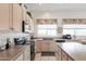 Bright kitchen features stainless steel appliances, island with seating, and tile flooring at 345 S Buena Vista Ave, Gilbert, AZ 85296