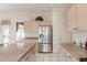 Bright kitchen features stainless steel appliances, island with seating, and tile flooring at 345 S Buena Vista Ave, Gilbert, AZ 85296