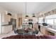 Bright kitchen features stainless steel appliances, island with seating, and tile flooring at 345 S Buena Vista Ave, Gilbert, AZ 85296