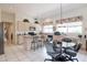 Bright and airy kitchen with tile flooring, neutral cabinets, and a breakfast bar with room to eat in at 345 S Buena Vista Ave, Gilbert, AZ 85296
