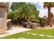 Outdoor kitchen with a built-in grill, perfect for entertaining guests in the landscaped backyard at 345 S Buena Vista Ave, Gilbert, AZ 85296