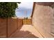 Large gravel side yard with a secure gate, offering plenty of space and privacy at 345 S Buena Vista Ave, Gilbert, AZ 85296