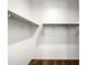 Walk in closet with built in shelving and railing and neutral carpeting at 35337 W San Alvarez Ave, Maricopa, AZ 85138