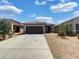Charming single-story home with a two-car garage, desert landscaping, and a welcoming entrance at 35337 W San Alvarez Ave, Maricopa, AZ 85138