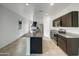 Modern kitchen with stainless steel appliances, a granite island, and ample cabinet space at 35337 W San Alvarez Ave, Maricopa, AZ 85138