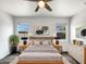Comfortable bedroom with natural light, ceiling fan, and neutral decor for a peaceful retreat at 35337 W San Alvarez Ave, Maricopa, AZ 85138