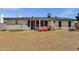 Spacious backyard featuring a covered patio, solar panels, and desert landscaping at 3709 W Grovers Ave, Glendale, AZ 85308