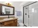 Modern bathroom with walk-in shower, vanity, and a spacious mirror at 3709 W Grovers Ave, Glendale, AZ 85308
