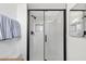 Modern bathroom featuring a glass-enclosed shower with white subway tile and sleek black fixtures at 3709 W Grovers Ave, Glendale, AZ 85308