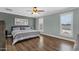 Large bedroom with hardwood floors, shuttered windows and a ceiling fan at 3709 W Grovers Ave, Glendale, AZ 85308