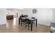 Inviting dining space with tiled flooring and backyard access, adjacent to a kitchen island with bar seating at 3709 W Grovers Ave, Glendale, AZ 85308