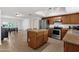 Well-lit kitchen with stainless steel appliances, adjacent to a dining area, offering both functionality and style at 3709 W Grovers Ave, Glendale, AZ 85308