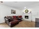 Cozy living room features a brick fireplace and comfortable sectional sofa at 3709 W Grovers Ave, Glendale, AZ 85308