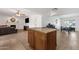 Spacious living area featuring a kitchen island with bar seating and a comfortable sitting area with a fireplace at 3709 W Grovers Ave, Glendale, AZ 85308