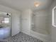 Bright bathroom featuring a shower-tub combo and stylish patterned floor tiles at 4005 W Carter Rd, Phoenix, AZ 85041