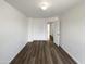 Inviting bedroom with wood-look floors and neutral walls, offering a serene and comfortable retreat at 4005 W Carter Rd, Phoenix, AZ 85041