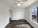 Bright bedroom features wood-look flooring, closet, ceiling fan, and large windows providing natural light at 4005 W Carter Rd, Phoenix, AZ 85041