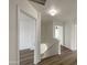 Hallway with wood-look floors, bright lighting, and doorways leading to various rooms at 4005 W Carter Rd, Phoenix, AZ 85041