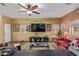 Comfortable living room with a ceiling fan and an eclectic arrangement of artwork at 44810 W Horse Mesa Rd, Maricopa, AZ 85139