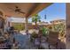 Relaxing covered patio with outdoor seating overlooking a beautiful backyard and pool at 44810 W Horse Mesa Rd, Maricopa, AZ 85139