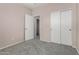 Bedroom with closet, neutral tones, carpet flooring, and a doorway leading to another space at 4653 W Dublin St, Chandler, AZ 85226
