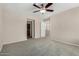 Spacious bedroom featuring neutral tones, carpet flooring, and a ceiling fan for added comfort at 4653 W Dublin St, Chandler, AZ 85226