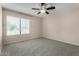 Neutral bedroom featuring a ceiling fan and window overlooking the neighborhood at 4653 W Dublin St, Chandler, AZ 85226