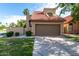 Inviting front exterior featuring desert landscaping, a two-car garage, and a red-tiled roof at 4653 W Dublin St, Chandler, AZ 85226