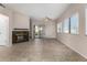 Spacious living room with tile floors, a ceiling fan, fireplace and a backyard view at 4653 W Dublin St, Chandler, AZ 85226