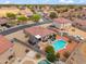 Aerial view of a home with a pool, pergola, and well landscaped backyard in a suburban neighborhood at 4728 N 92Nd Ave, Phoenix, AZ 85037