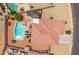 Aerial view of a backyard pool, outdoor seating, and terracotta roof in a desert landscape at 4728 N 92Nd Ave, Phoenix, AZ 85037