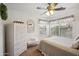 Bright bedroom with white furnishings, ceiling fan, and sunlit window at 4728 N 92Nd Ave, Phoenix, AZ 85037
