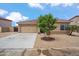 Front exterior view of a home featuring low maintenance landscaping, neutral color palette, and attached two car garage at 4728 N 92Nd Ave, Phoenix, AZ 85037