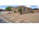 A home featuring desert landscaping, small palm trees, and a charming terracotta-colored roof at 4728 N 92Nd Ave, Phoenix, AZ 85037
