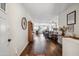 Foyer view with wood-look flooring, neutral walls, and open concept layout to kitchen and living room at 4728 N 92Nd Ave, Phoenix, AZ 85037