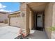 Exterior view featuring the front door with sidelight, landscaping, and two car garage at 4728 N 92Nd Ave, Phoenix, AZ 85037