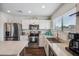 Well-lit kitchen featuring stainless steel appliances, granite countertops, and ample cabinet space at 4728 N 92Nd Ave, Phoenix, AZ 85037