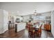 Open concept kitchen featuring stainless steel appliances, an island, white cabinets, and dining area at 4728 N 92Nd Ave, Phoenix, AZ 85037