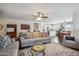 Spacious living room featuring wood look floors and an open concept to the kitchen and dining area at 4728 N 92Nd Ave, Phoenix, AZ 85037