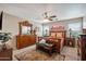 Spacious main bedroom featuring wood furniture, ceiling fan, and natural light from multiple windows at 4728 N 92Nd Ave, Phoenix, AZ 85037