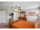 Comfortable main bedroom with warm tones, dresser, and view into the walk-in closet at 4728 N 92Nd Ave, Phoenix, AZ 85037