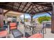 Shaded patio includes a hot tub, seating area, BBQ and view of backyard pool at 4728 N 92Nd Ave, Phoenix, AZ 85037