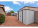 Backyard view of storage shed with door, side walls and fencing at 4728 N 92Nd Ave, Phoenix, AZ 85037
