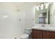Bathroom featuring a shower, toilet, and wood vanity with a sink and modern lighting at 4743 N 26Th Ln, Phoenix, AZ 85017